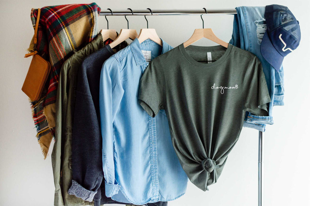 military green short sleeve tshirt printed with dog mom in lower case script writing with a little paw print in white ink placed over the left chest