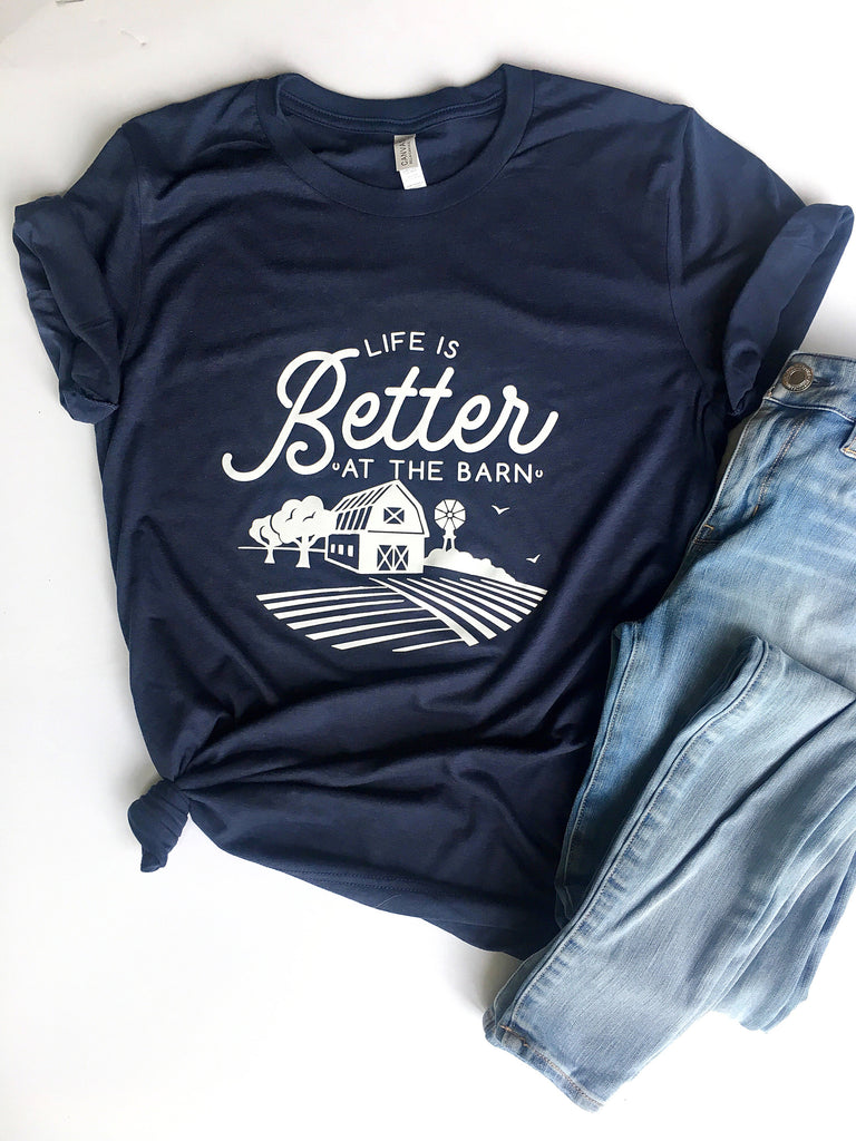navy  blue short sleeve graphic tshirt that reads life is better at the barn with a barn scene.